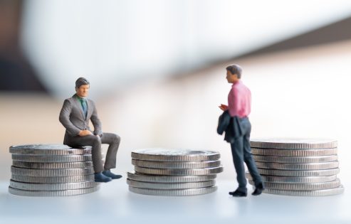 Miniature people businessman with coins