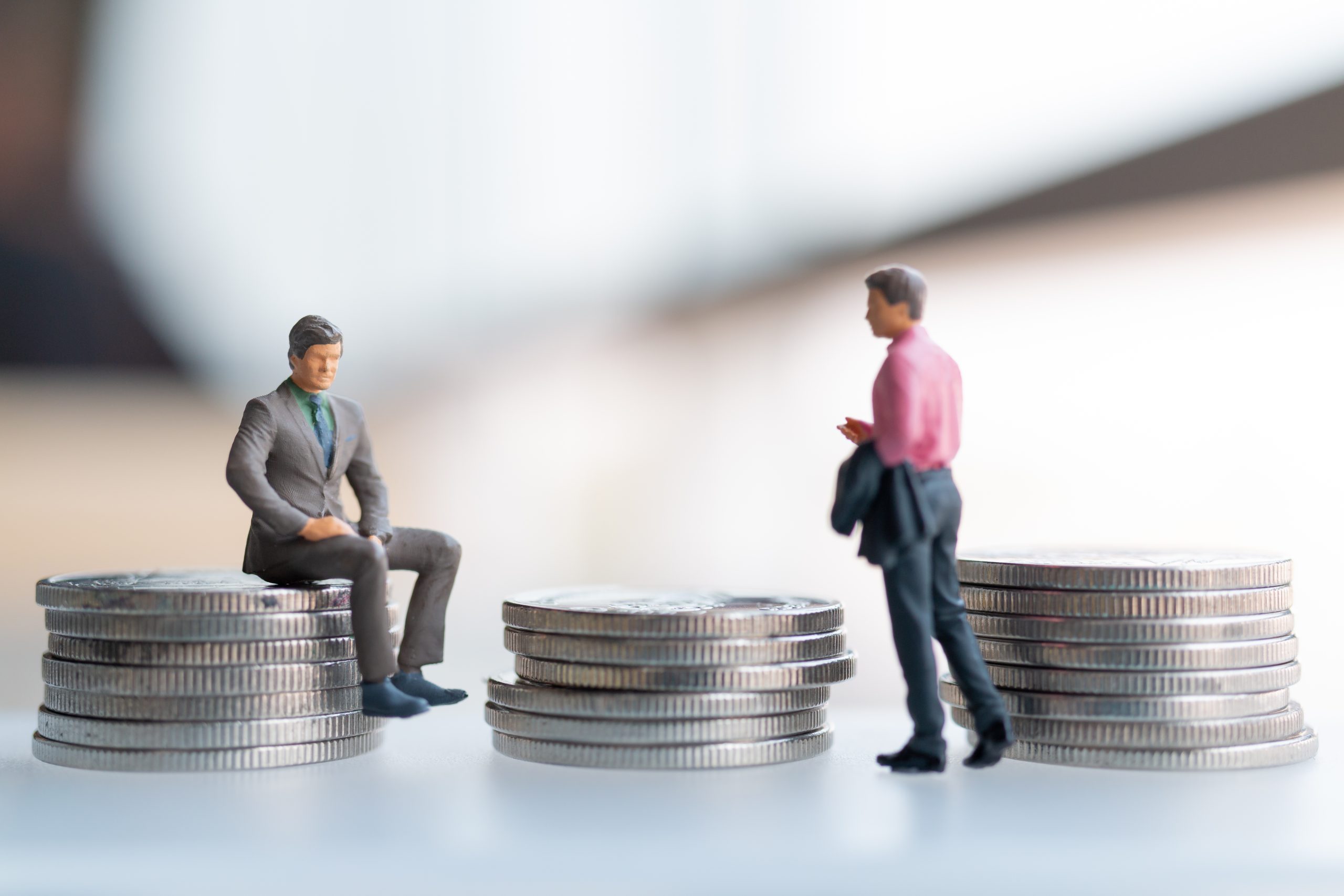 Miniature people businessman with coins