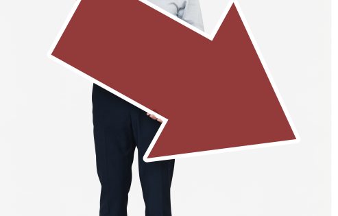 An unhappy businessman holding a red arrow